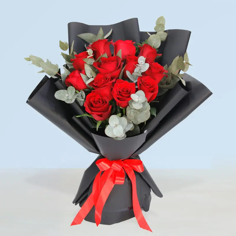 Valentines - Dozen Red Roses 12-stem red roses with eucalyptus in black bouquet paper tied with red ribbon for Valentine's Day