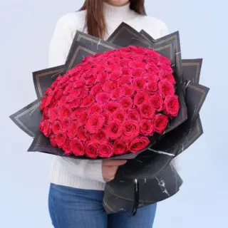 A stunning bouquet of 85-90 deep pink roses, symbolizing passion, gratitude, and joy in a rich, velvety display.