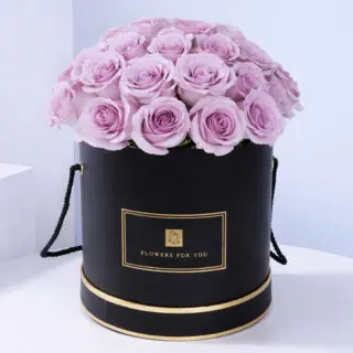 A luxurious box filled with vibrant purple roses, symbolizing love and desire, perfect for gifting or self-indulgence.
