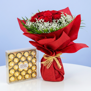 A bouquet of 10 red roses with gypsophila and greenery, wrapped in red paper and paired with a box of Ferrero Rocher chocolates.