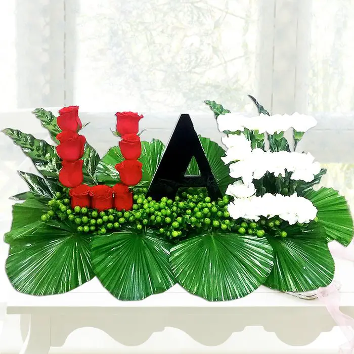 uae-national-day-bouquet_1.png UAE is written using red, black, white and green flowers and leaves