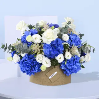 Beautiful floral centerpiece with a mix of blue hydrangeas and white roses