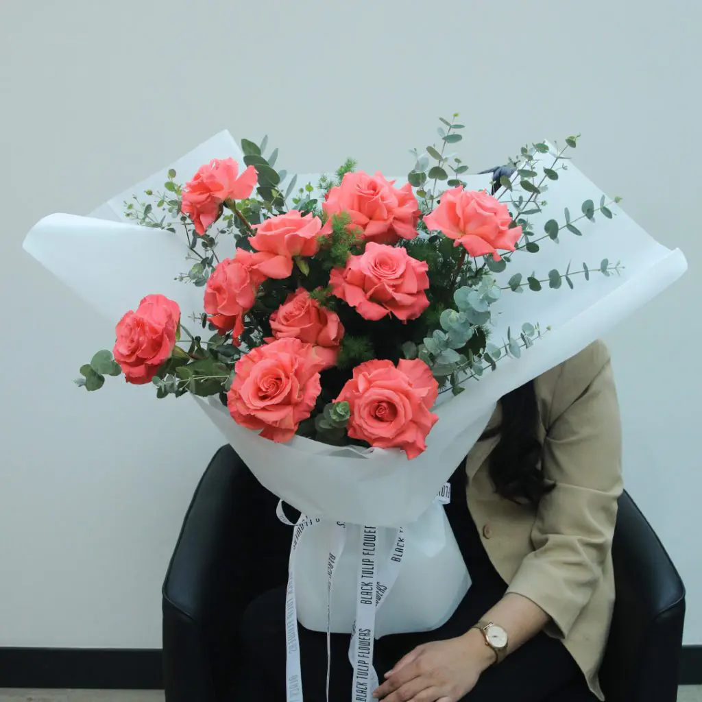 1929 Fresh 10 roses with greenery, neatly wrapped in white and tied with a white ribbon.