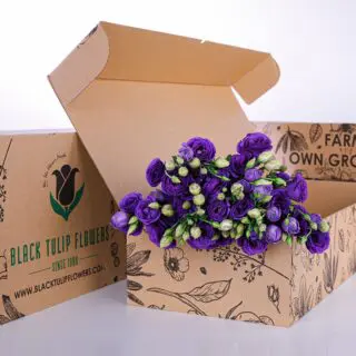 A cardboard box filled with vibrant blue Lisianthus flowers, showcasing their delicate petals and lush greenery.