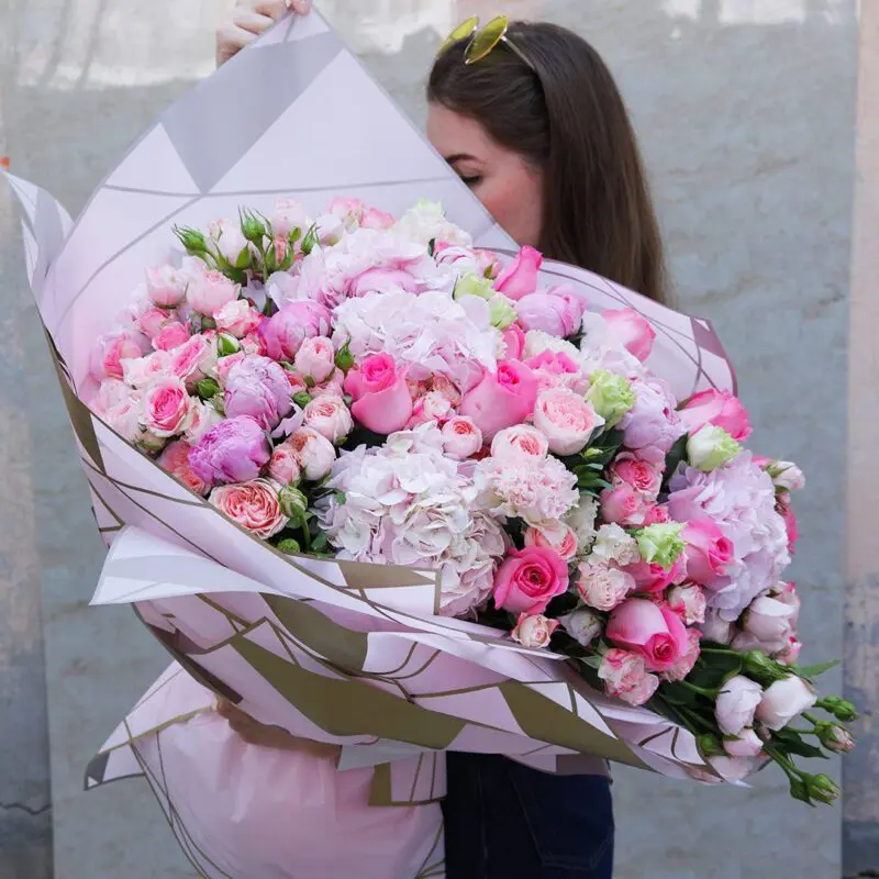 Nurturing Pink Bouquet (1) A charming mix of pink flowers wrapped in a delicate pink wrap.