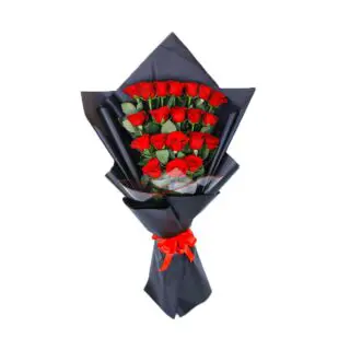 A bouquet of red roses in a black wrap tied with red ribbon.