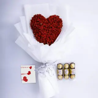 Red heart-shaped gypsophila bouquet, Ferrero chocolates, and a message card in a white wrap tied with a white ribbon.