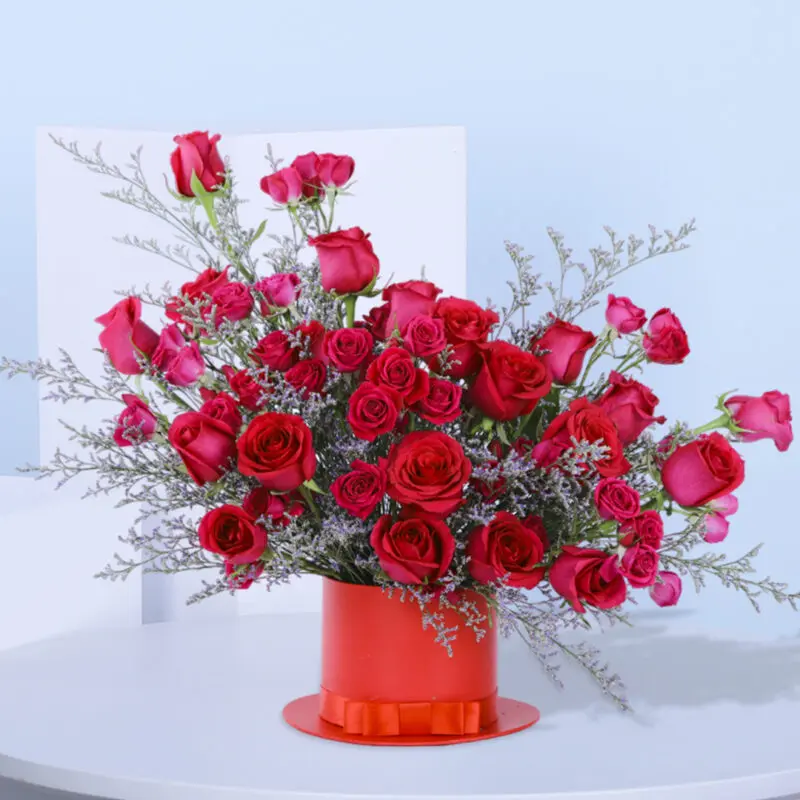 1 (62) Luxurious dark pink spray roses with Caspia fillers in a red hat box with a bow.