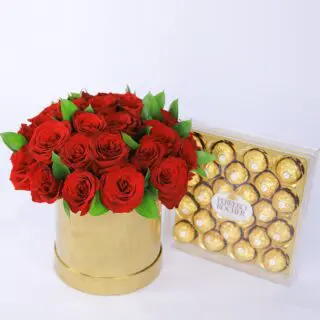 Red rose arrangement in a gold box with a box of Ferrero Rocher chocolates