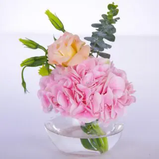 Pink centerpiece flower arrangement consists of Hydrangeas, Lisianthus and Eucalyptus