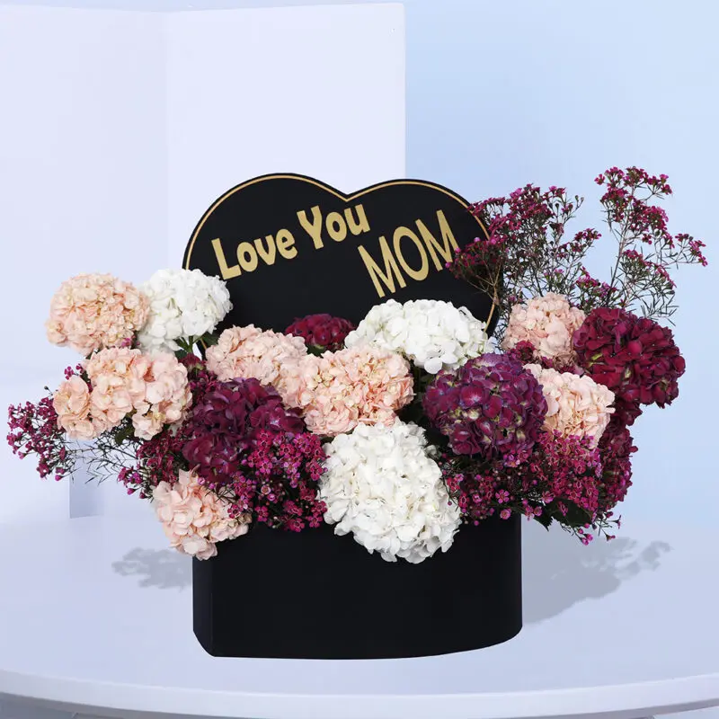 Heartfelt Mother's Day gift basket with mixed colorful hydrangeas and a "Love You Mom" card.