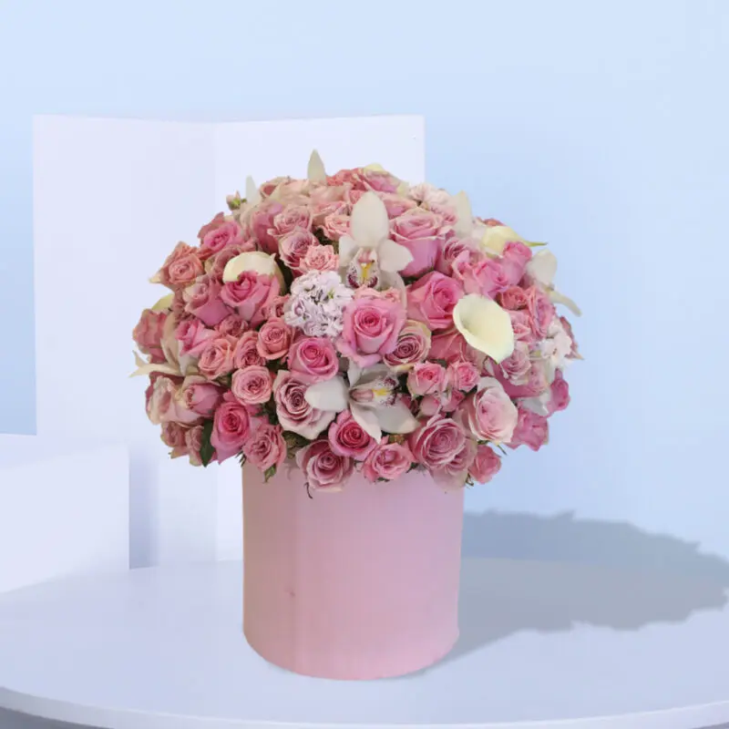 1 (126) A large pink box filled with pink roses, white calla lilies, and white orchids.