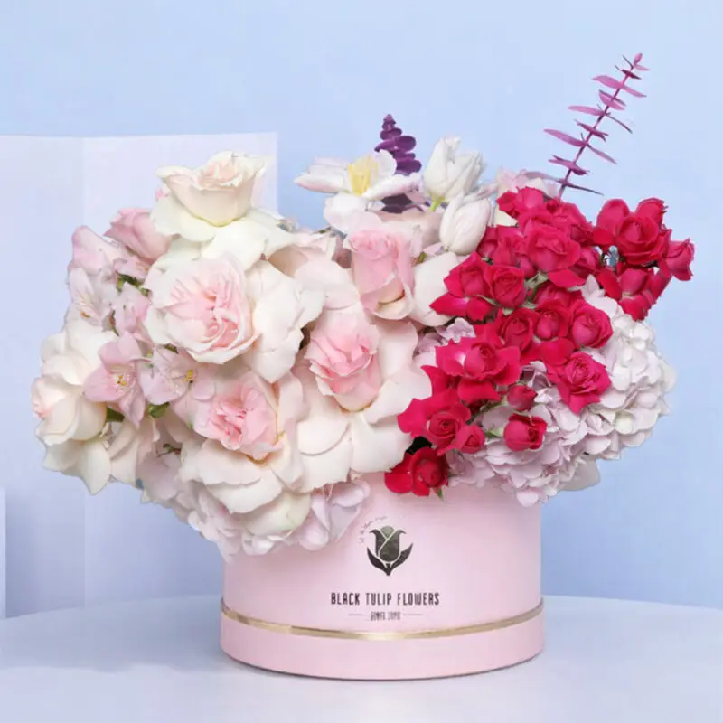 artful-pink-box-2026 A beautiful "Pink Box" filled with light pink roses, dark pink spray roses, pink tulips, pink hydrangeas, and eucalyptus.