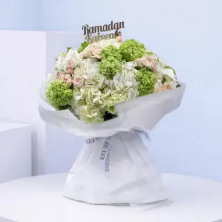 Ramadan kareem floral arrangement with f white hydrangeas, green viburnum, and pink roses.