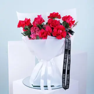 Beautiful bouquet of 10 pink roses, 4 hydrangeas, and wax pink wrapped in a white sheet and ribbon.