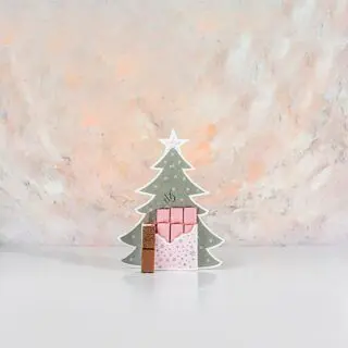 An assortment of pink Christmas-themed chocolates, beautifully crafted for a delightful holiday indulgence.
