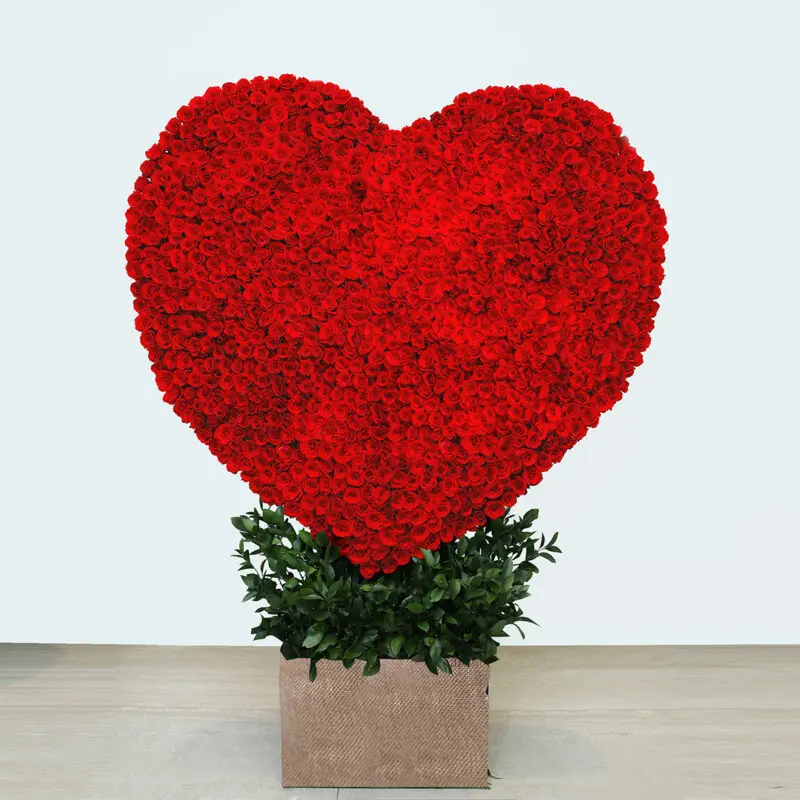Heart-shaped arrangement of 1000 stem red roses in a rustic planter- perfect romantic gift