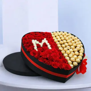 Detailed view of a Heart-shaped box featuring 50 red roses, 5 spray white roses, and 60-70 Ferrero Rocher chocolates.