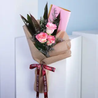 A bouquet of pink roses wrapped in brown paper with a decorative ribbon.