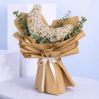 A bouquet featuring colorful Gypsophila flowers complemented by Eucalyptus leaves.