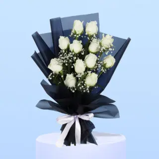White roses and gypsophila wrapped in sleek black, tied with a classic white ribbon.