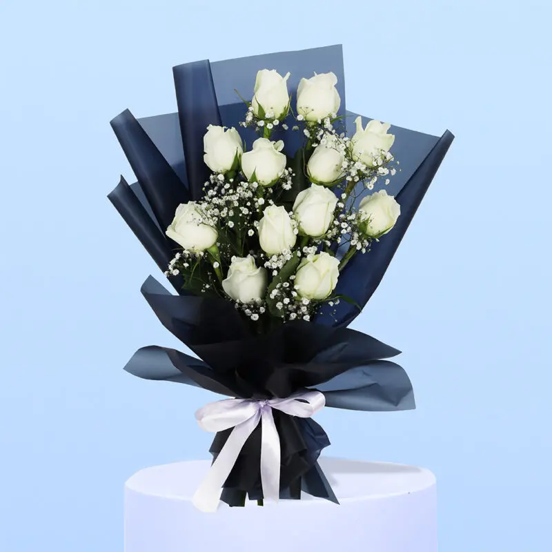 White roses and gypsophila wrapped in sleek black, tied with a classic white ribbon.