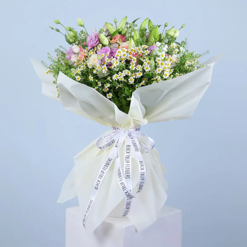 01 A large, colorful bouquet featuring pink gerberas, pink roses, white ohara, tanacetrum, bublurium, white lilies and more