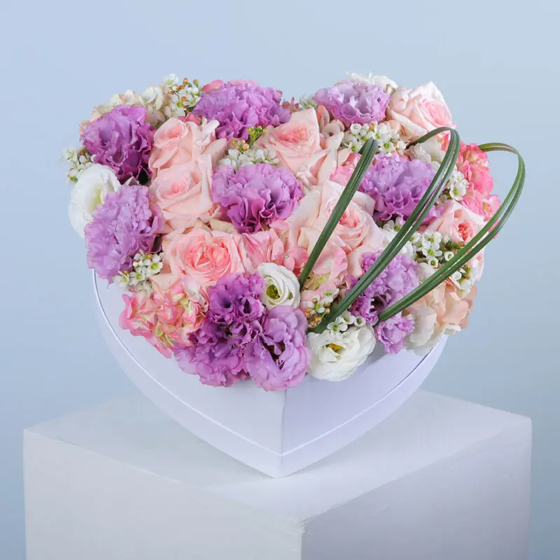01 Heart-shaped box containing pink ohara stems, purple lisianthus, pink hydrangea, and stems of wax and steel grass.