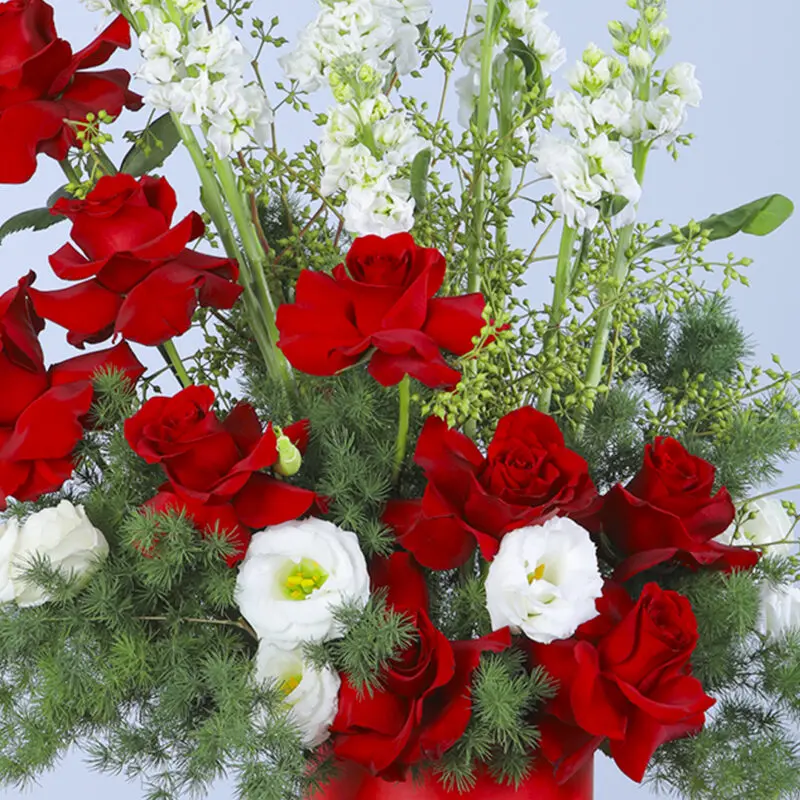 Close-up view Bouquet of red roses, mathiolla, white lisianthus, and greenery