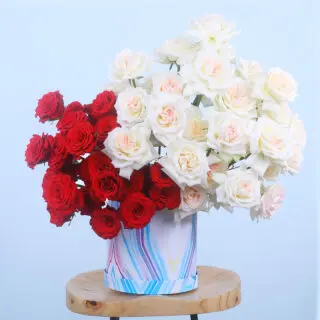 Marble-patterned box with 20 red roses and 30 white O'Hara roses.