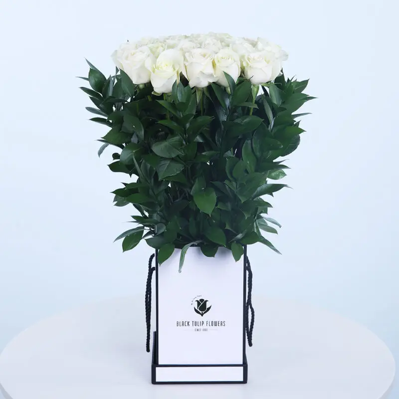 A bouquet of 15 long-stemmed white roses in a Small box with a white ribbon.
