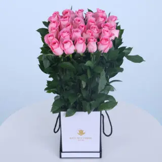 15 Blush pink roses in a white floral bag