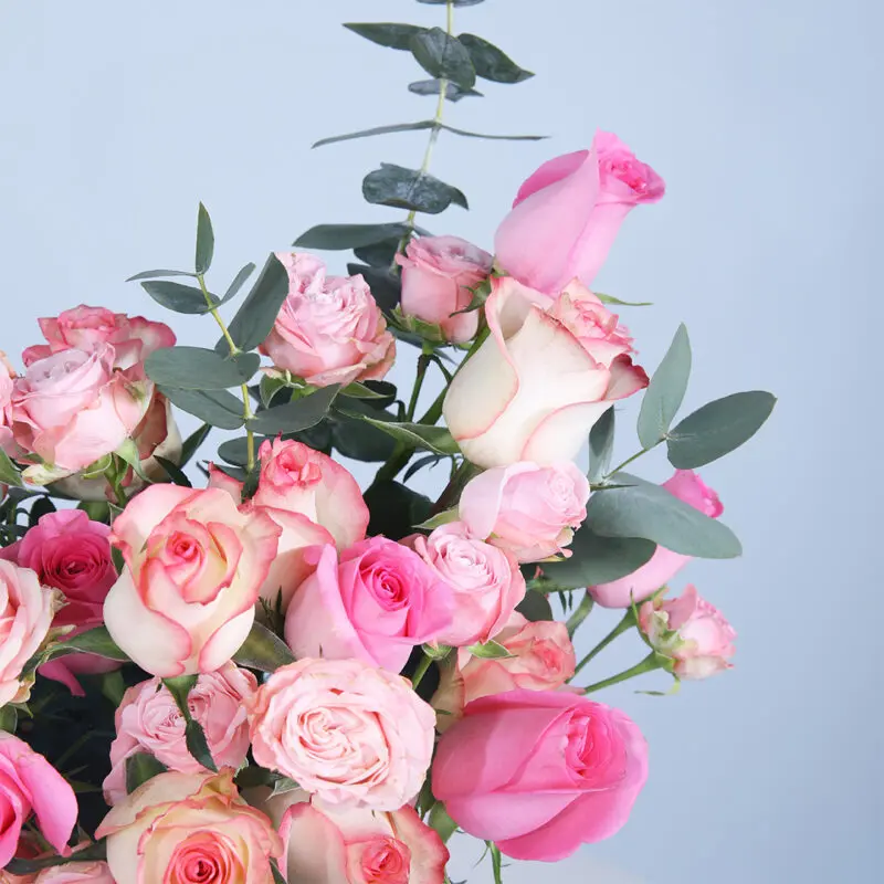03 - Mixed Rose Beauty Box Mixed rose bouquet with pink, Jumelia, and baby roses complemented by fresh leaves in a stylish box.