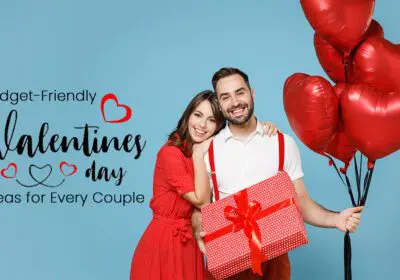 A Valentine's Day-themed image with a heart-shaped arrangement of red roses. The arrangement is placed on a wooden table with a small gift box and a card that says "Budget-Friendly Valentine's Day Ideas for Every Couple."
