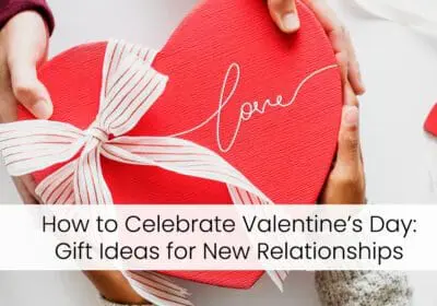 Two hands, one light and one dark, holding a heart-shaped gift box with a red ribbon and the word "Love" written on it. The text "How to Celebrate Valentine's Day: Gift Ideas for New Relationships" is displayed below the image.