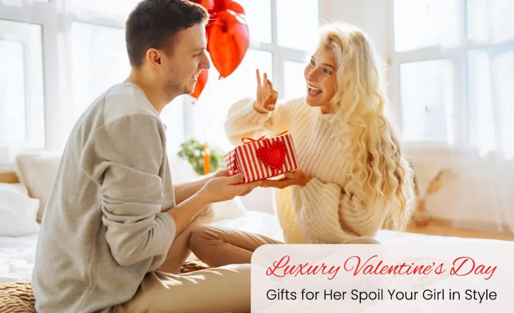 A couple sitting close together, exchanging gifts and smiling.