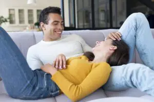 A happy couple enjoying a relaxing moment together on a sofa