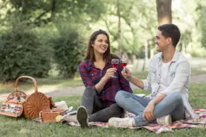 lovely-couple-clinking-wine-glasses-picnic-scaled
