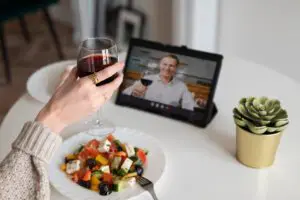 A virtual couple enjoying a romantic dinner with wine