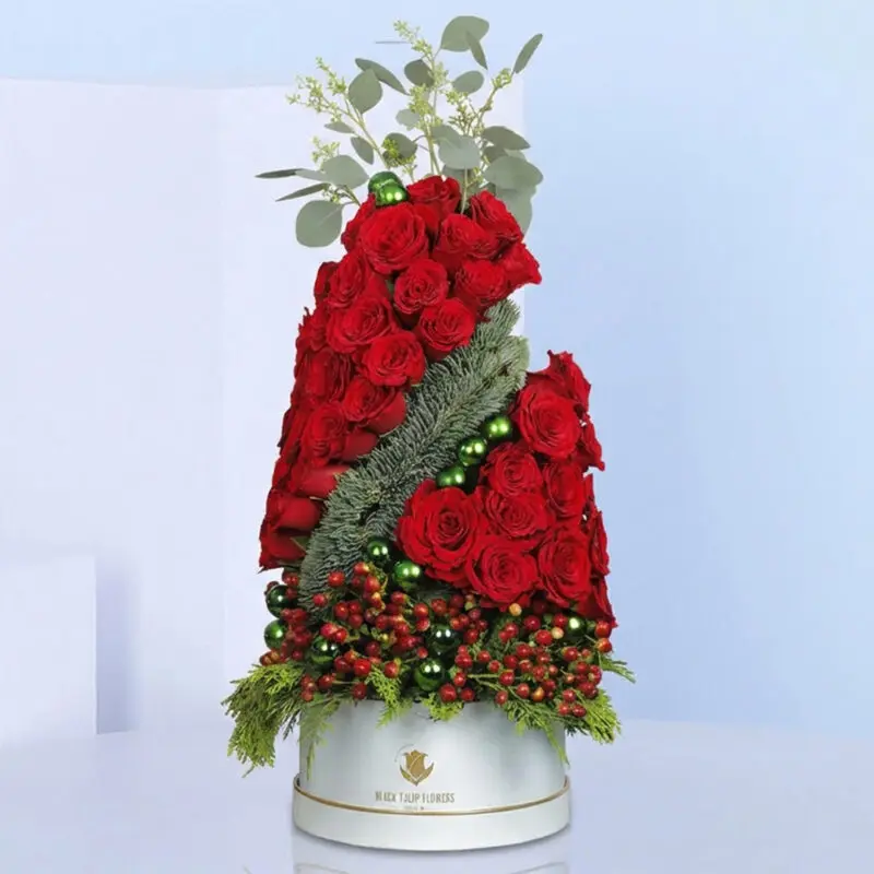 Luxury-Festive-Rose-Tree-06-12-25-01 A vibrant red rose arrangement elegantly displayed in a classic white vase, showcasing natural beauty and sophistication.