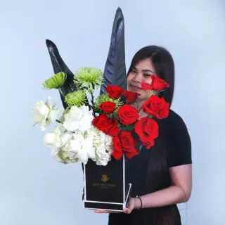 UAE National Day flower box with hydrangeas, roses, delistar greens, and fresh leaves, designed for easy carrying.