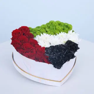 UAE Flag-themed white heart box with red roses and white spray black roses.