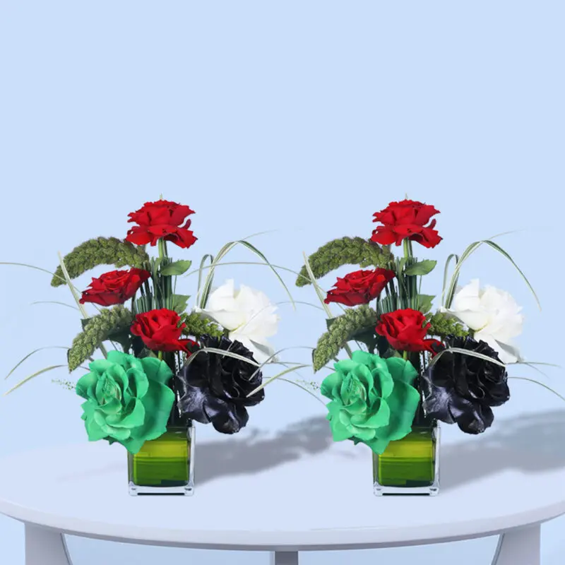three-roses-in-glass-vase Floral arrangement with red, white, and black roses, accented by greenery and designed in a modern glass vase.