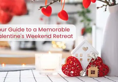 A Valentine's Day themed image with a candle, decorative hearts, a small house figurine, and keys. The text "Your Guide to a Memorable Valentine's Weekend Retreat" is displayed above the image