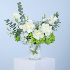 A vase containing an arrangement of white and green flowers, showcasing a harmonious blend of colors and textures.