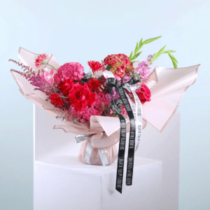 A vibrant bouquet of flowers elegantly tied with a decorative ribbon, showcasing a variety of colors and textures.