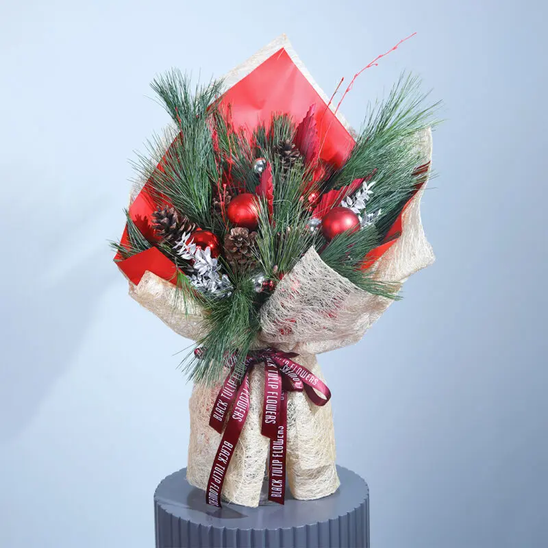christmas-bouquet A festive Christmas bouquet with red and green blooms, pinecones, and ornaments.