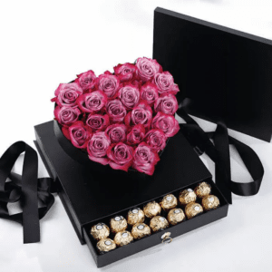 A black box adorned with a heart-shaped arrangement of red roses and assorted chocolates, symbolizing love and affection.