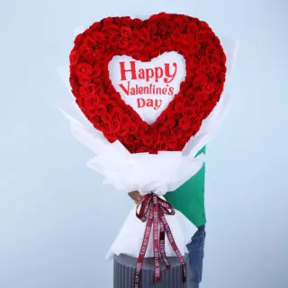 A heart shaped arrangement of 300 res roses with "Happy Valentine's Day" message.