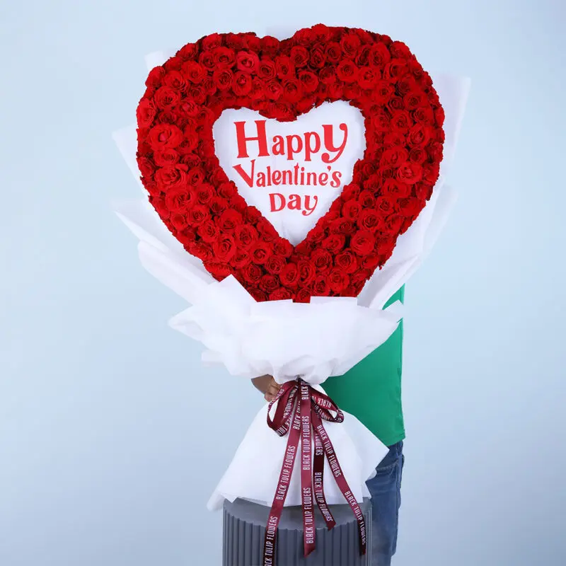 A heart shaped arrangement of 300 res roses with "Happy Valentine's Day" message.